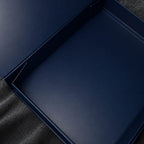 Blue open box on a textured black surface