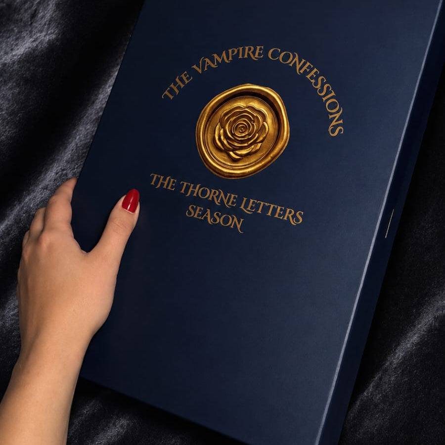 Blue book titled 'The Vampire Confessions' on a dark fabric background